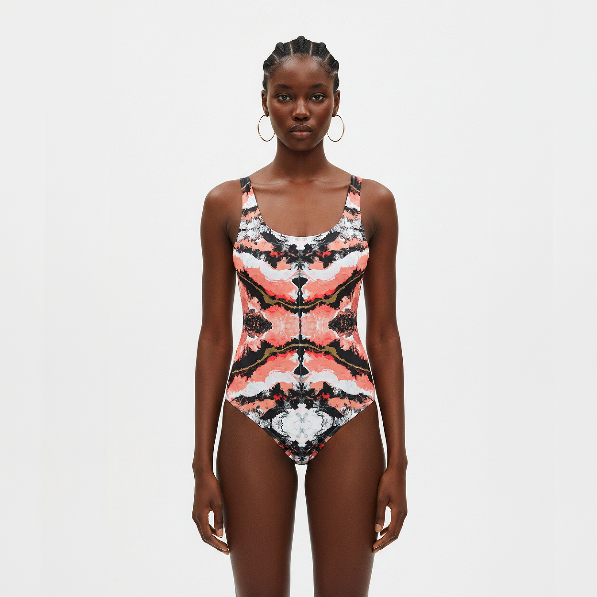 Woman wearing a patterned swimsuit on a light gray background