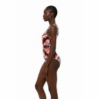Woman wearing a floral one-piece swimsuit on a white background