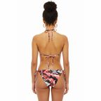 Woman wearing a colorful bikini on a white background
