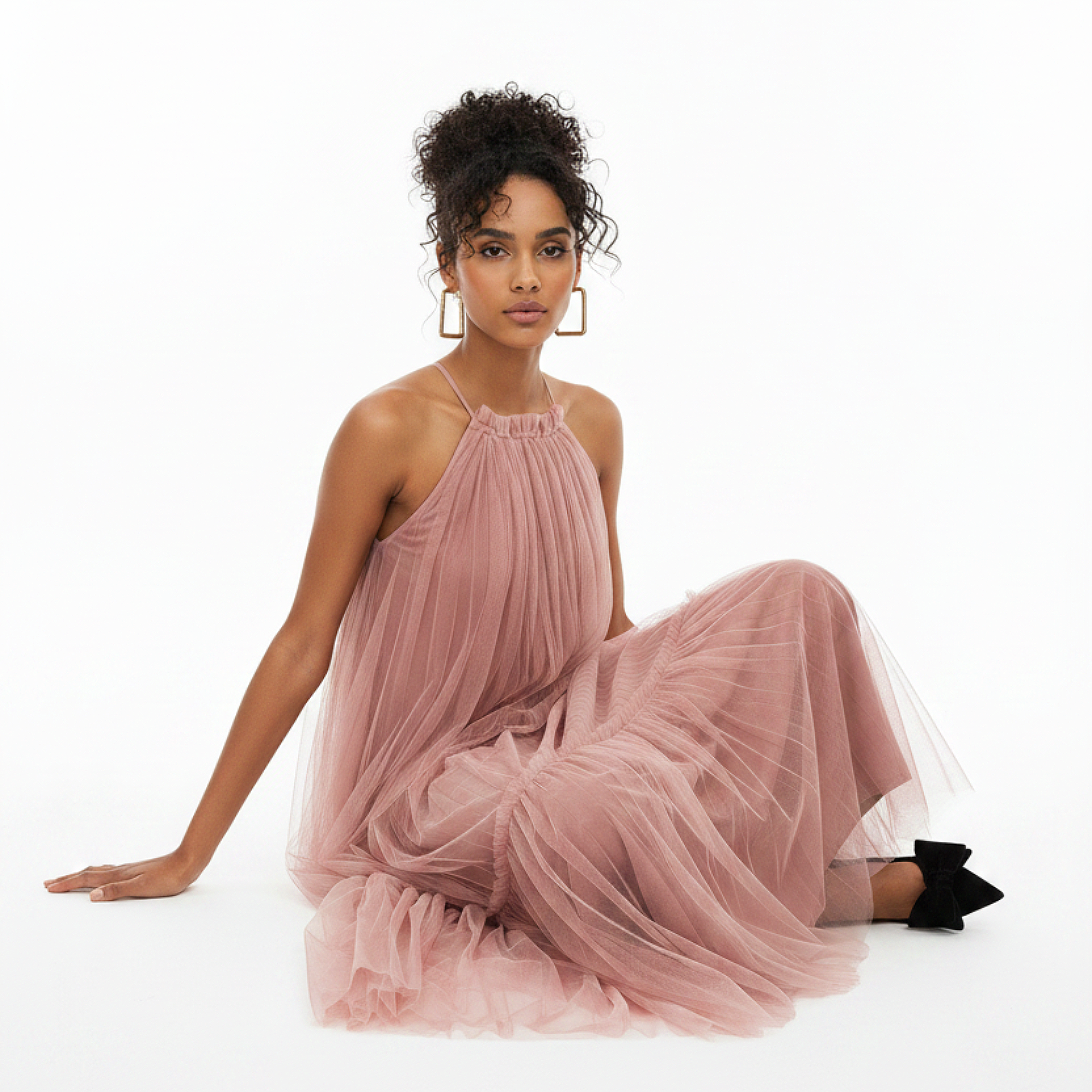 Woman wearing a pink tulle dress on a white background