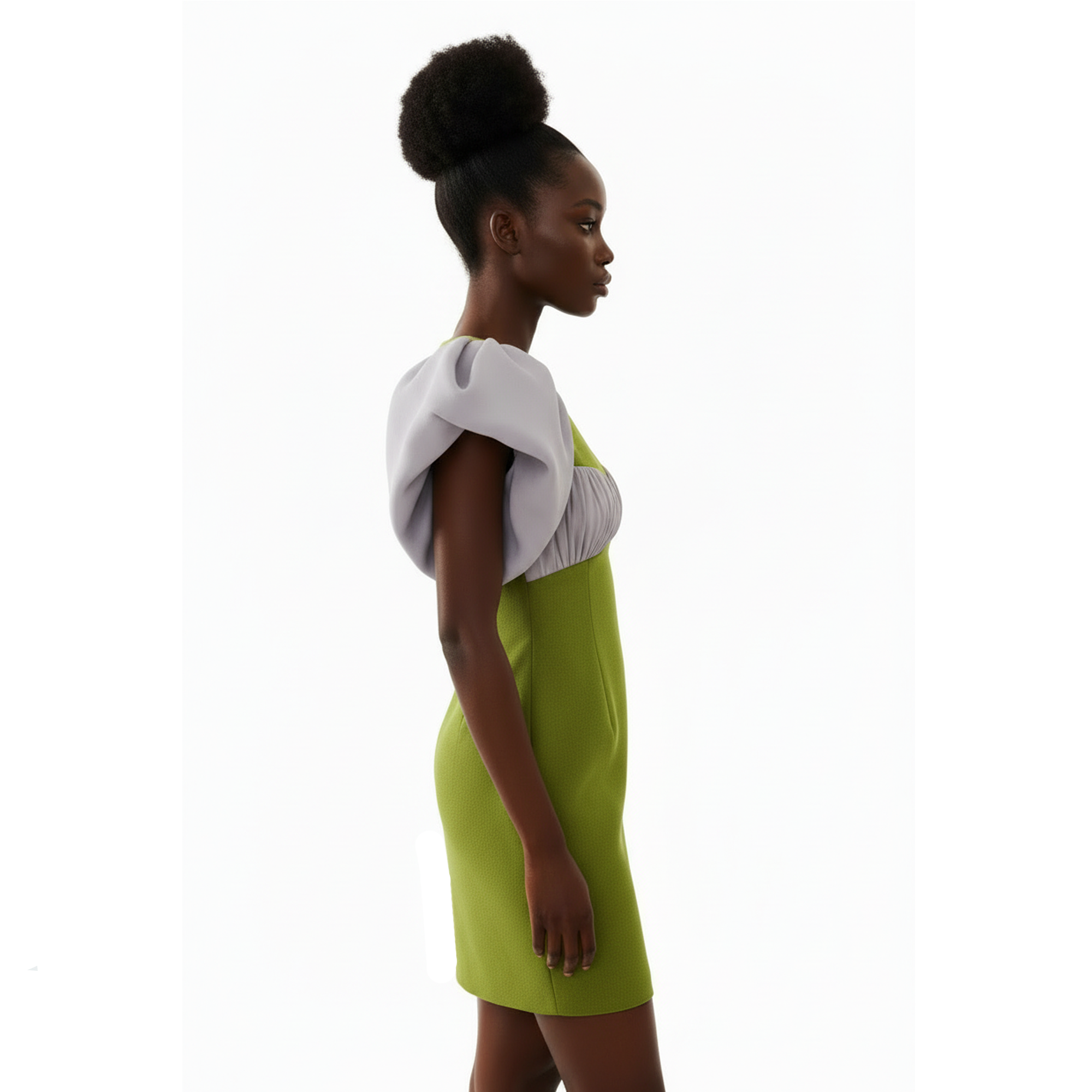 Woman wearing a green dress with a white top on a white background