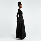 Woman wearing a long black dress on a white background