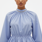 Light blue dress with long sleeves on a plain background