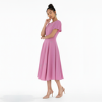 Woman wearing a pink dress on a white background
