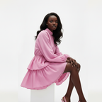 Woman wearing a pink dress on a white background