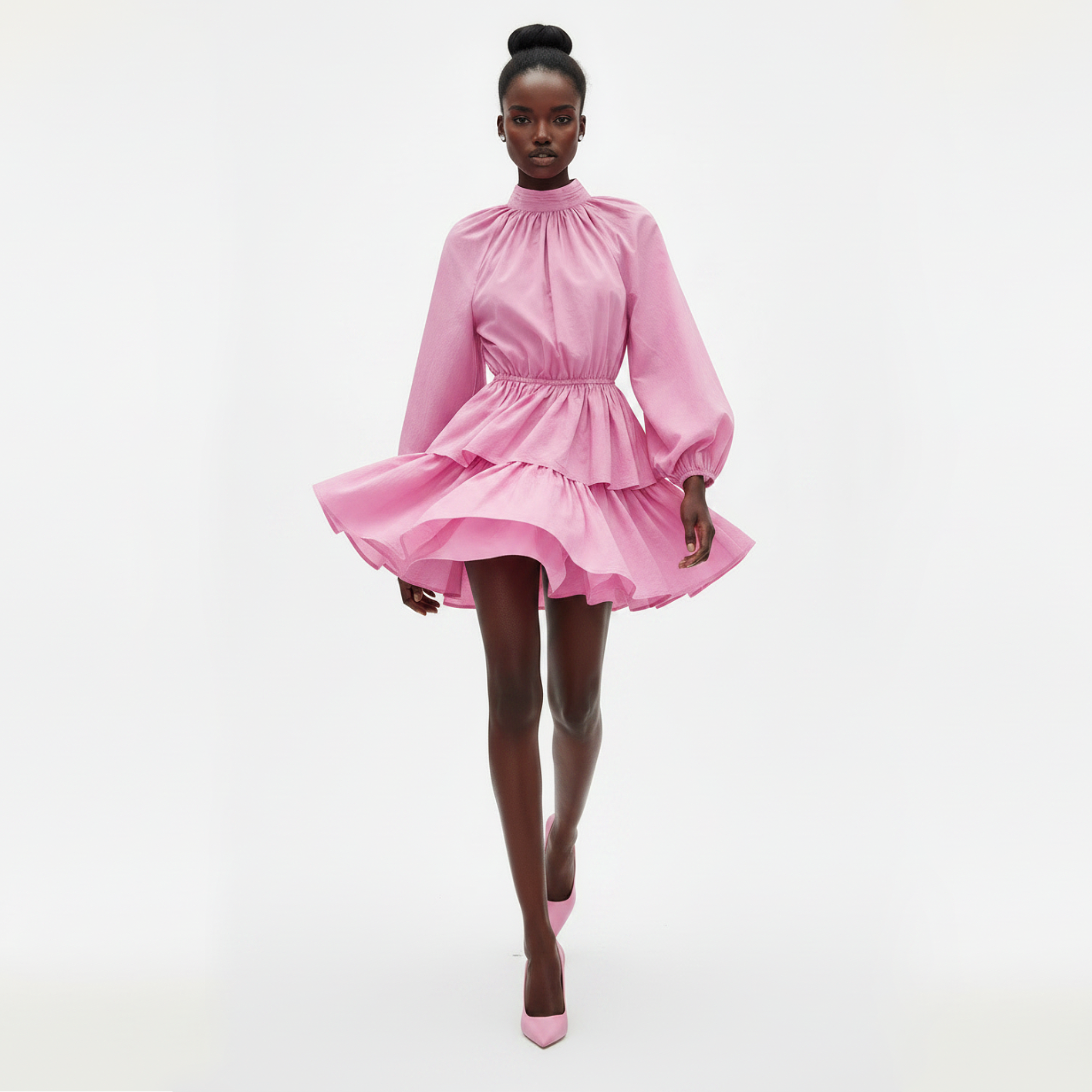 Woman wearing a pink dress on a light gray background
