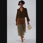 Woman wearing a brown jacket and skirt with a beige tulle hem on a white background