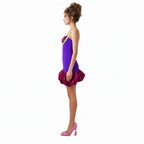Woman wearing a purple dress with pink floral accents on a white background