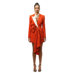 Woman wearing a bright orange blazer dress with a white collar on a white background