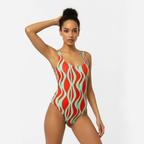 Woman wearing a red and green patterned swimsuit on a white background