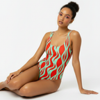 Woman wearing a red and green patterned swimsuit on a white background