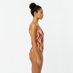 Woman wearing a colorful swimsuit with a white background