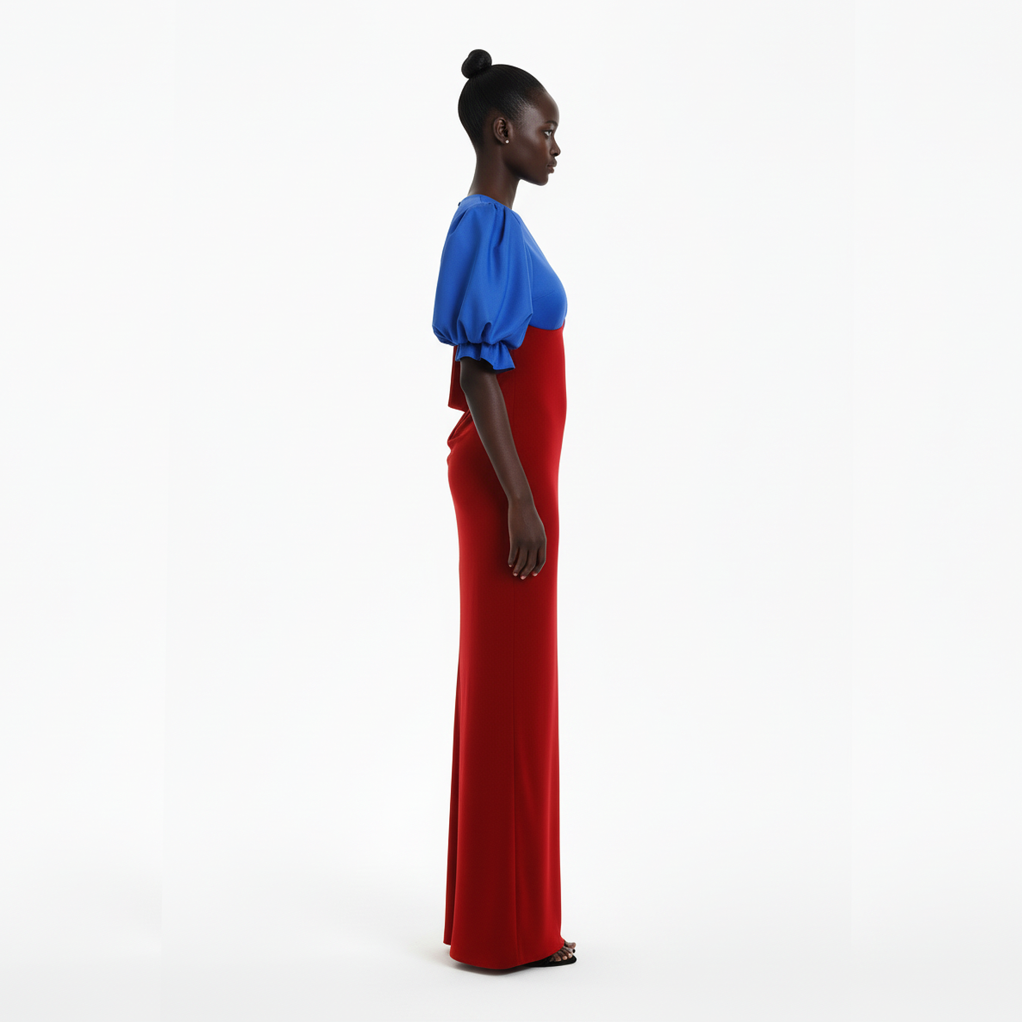 Woman wearing a blue top and red dress on a white background