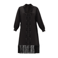Black dress with ruffled details and fringe on a white background