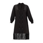 Black dress with ruffled details and fringe on a white background