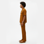 Man wearing a mustard yellow outfit on a white background
