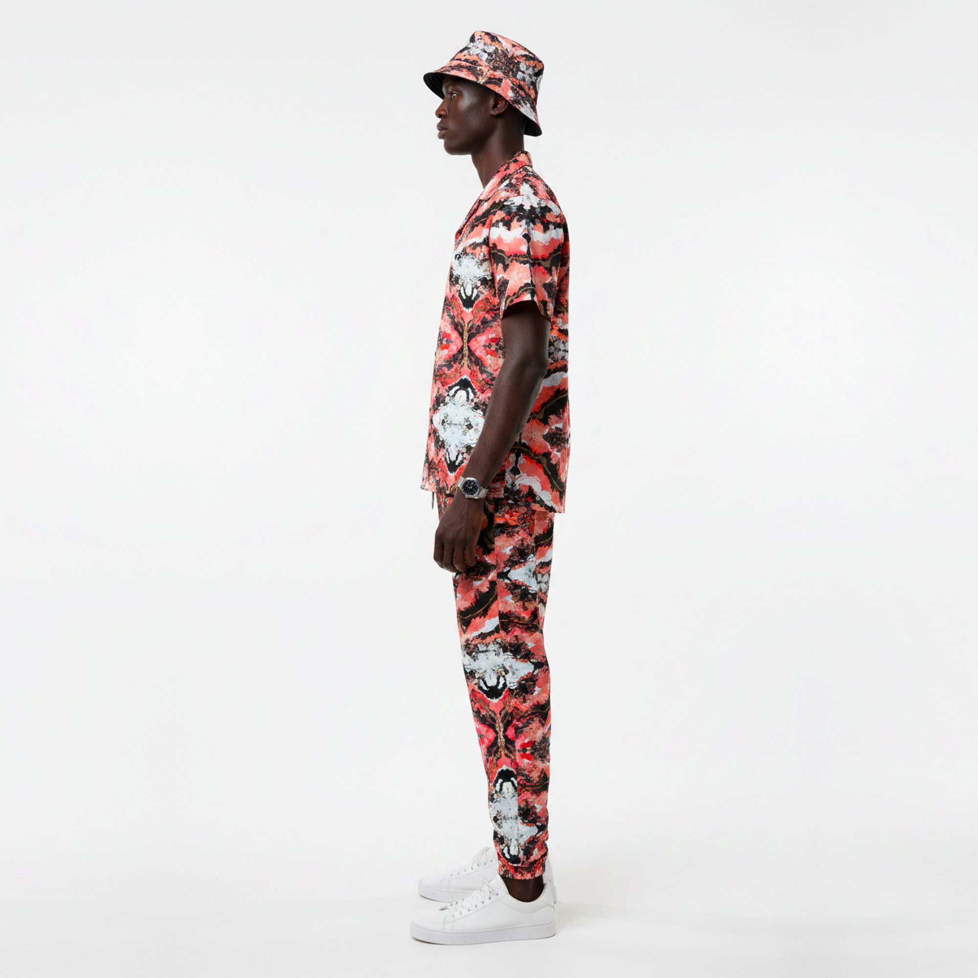 Person wearing a colorful floral outfit on a white background