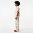 Person wearing a patterned pajama set on a white background