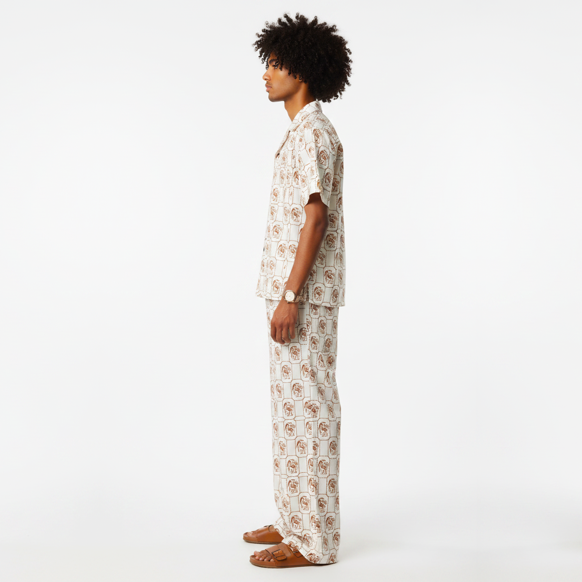 Person wearing a patterned pajama set on a white background