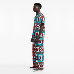 Man wearing a colorful patterned outfit on a white background