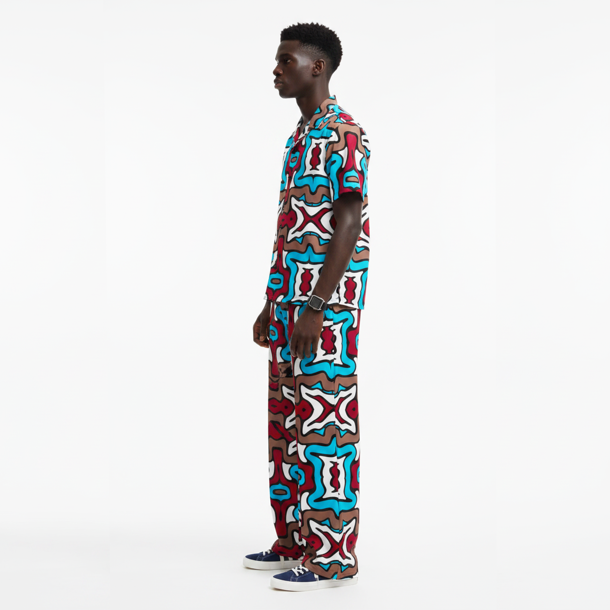 Man wearing a colorful patterned outfit on a white background