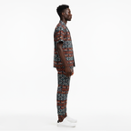 Man wearing a patterned outfit on a white background