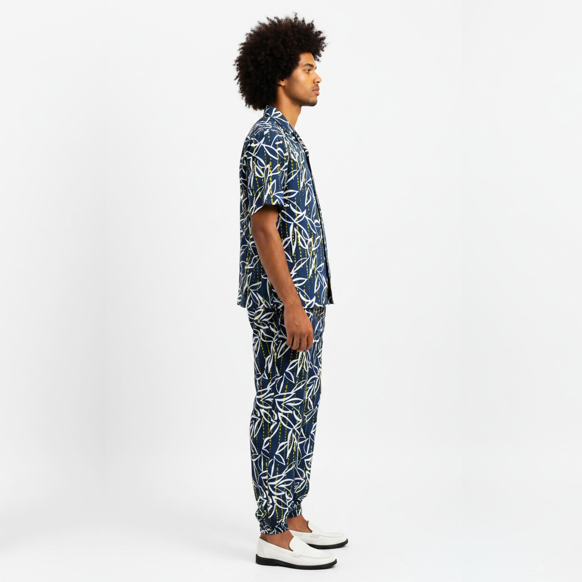 Man wearing a blue patterned outfit on a white background