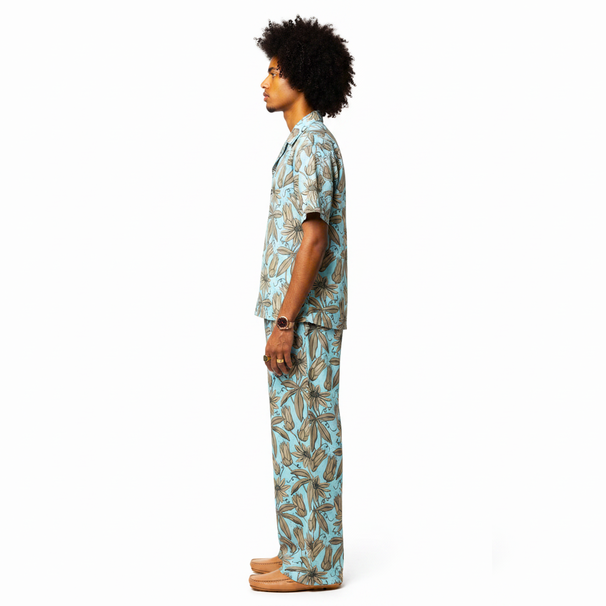 Person wearing a blue and green patterned outfit on a white background