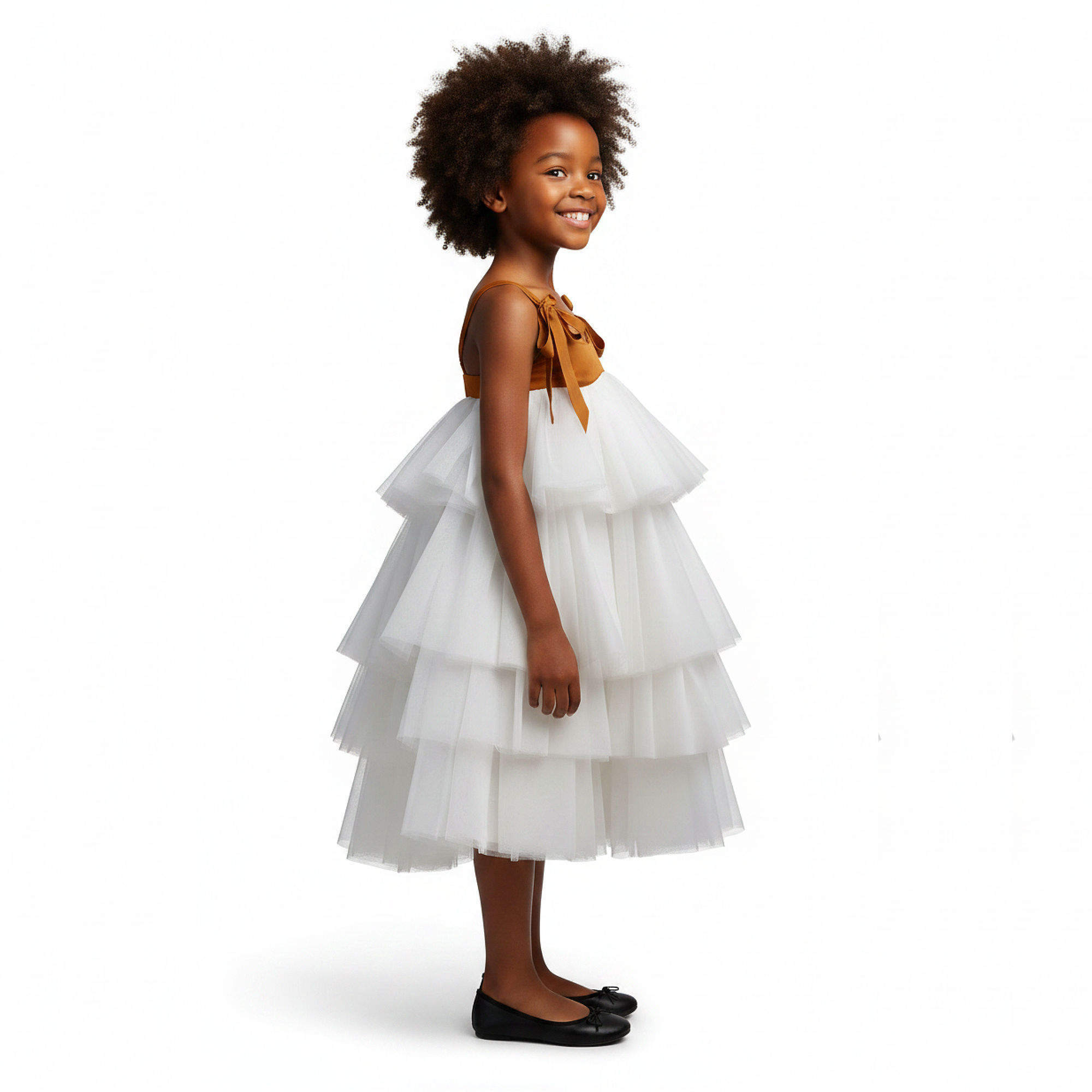 Young girl wearing a white tiered dress with a brown top on a black background