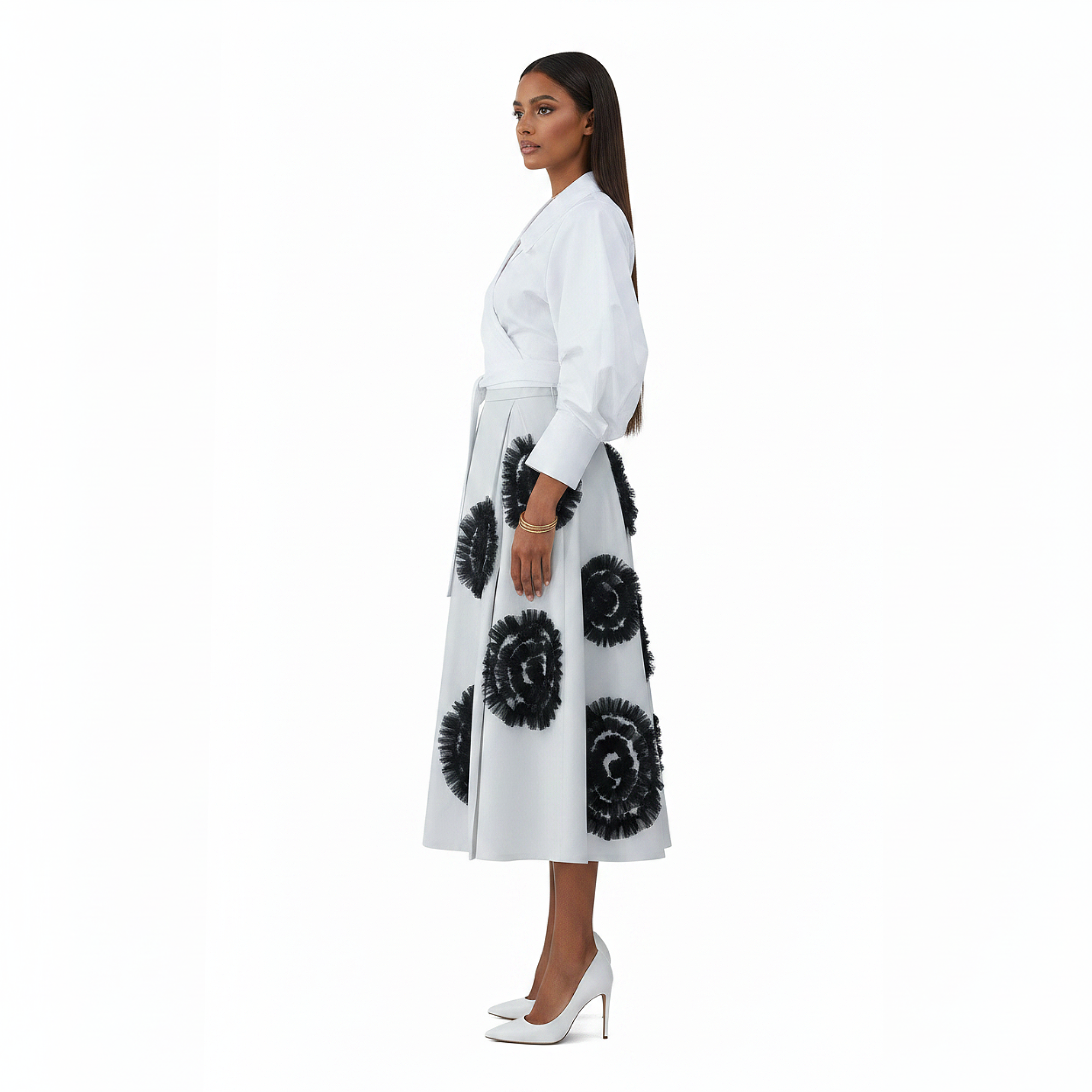 Woman wearing a white coat with black floral patterns on a white background