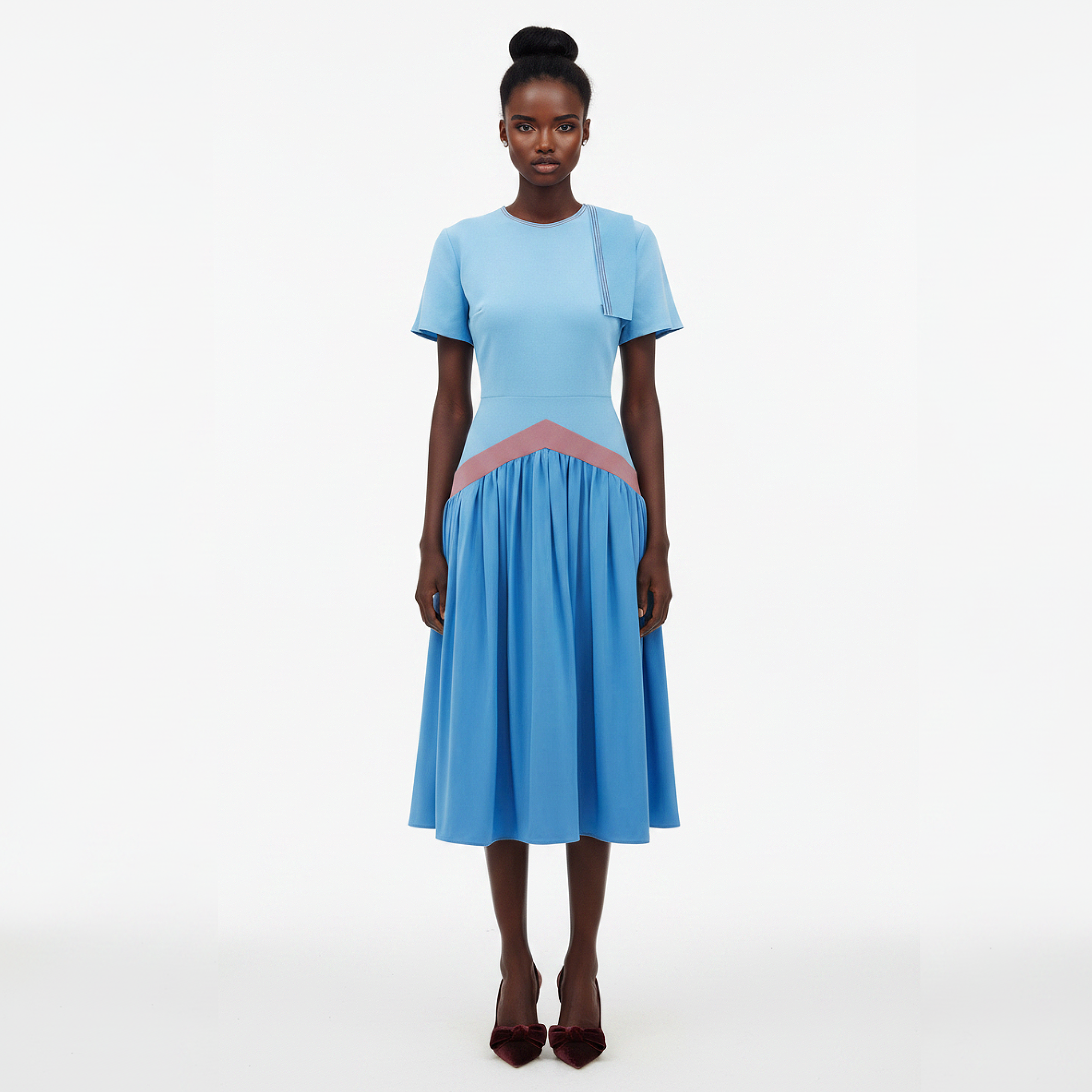 Woman wearing a light blue dress with a pink accent on a white background