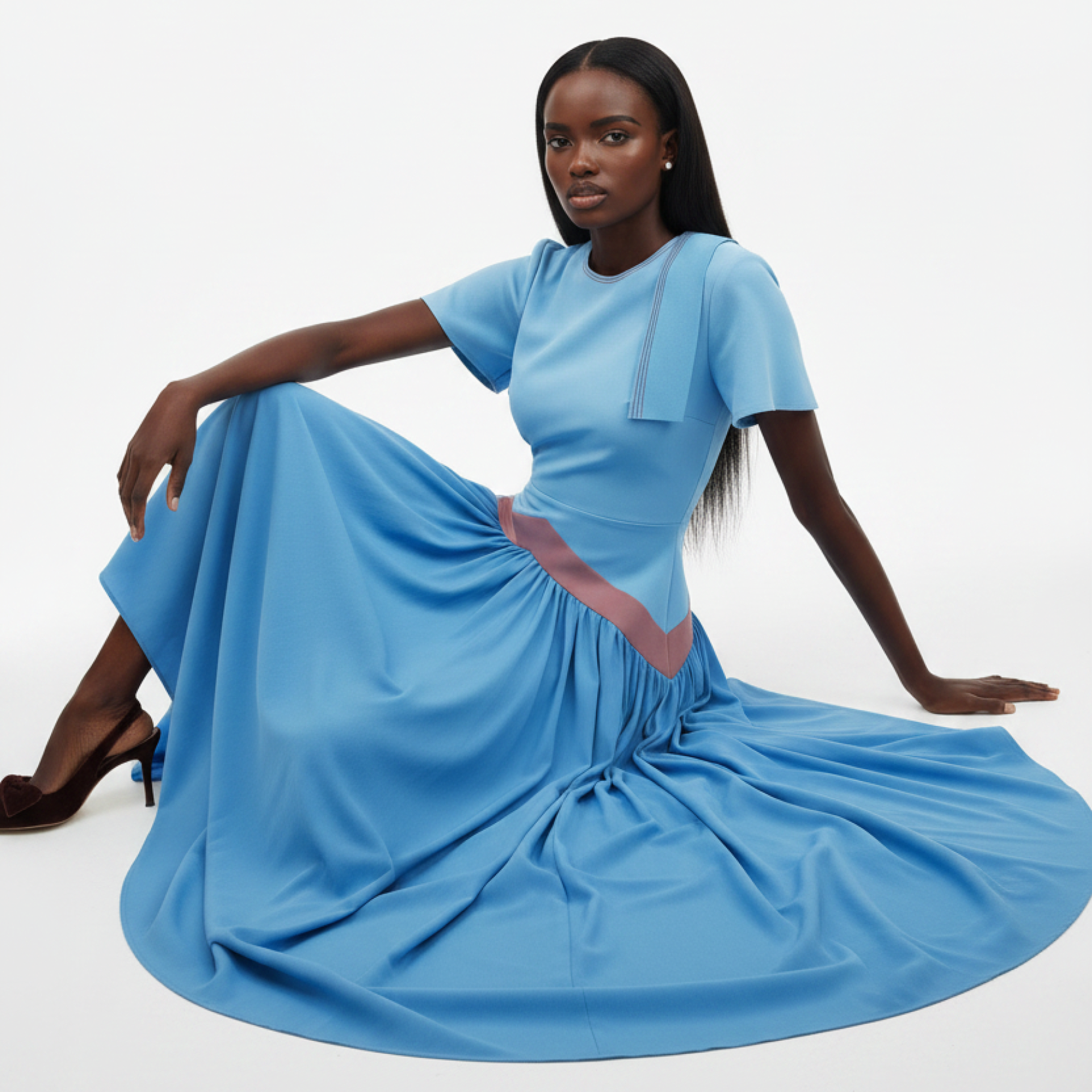 Woman wearing a blue dress with a flowing skirt on a white background