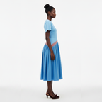 Woman wearing a blue dress with a white background