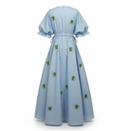 Light blue dress with green floral patterns on a white background