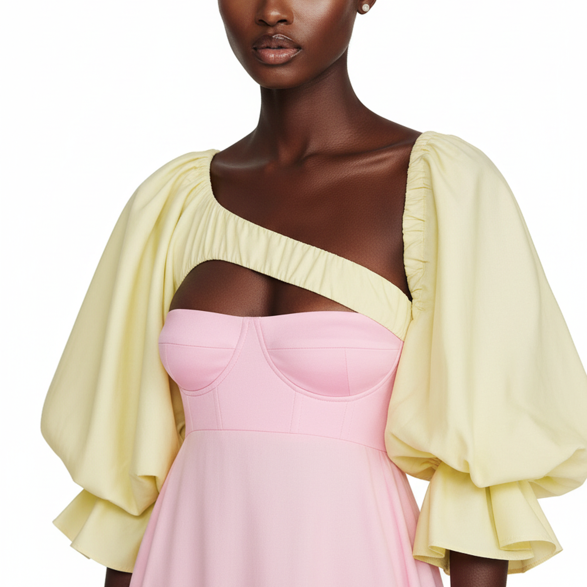 Woman wearing a yellow top and pink dress on a white background