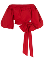 Red off-shoulder top with puff sleeves and a tie detail on a white background