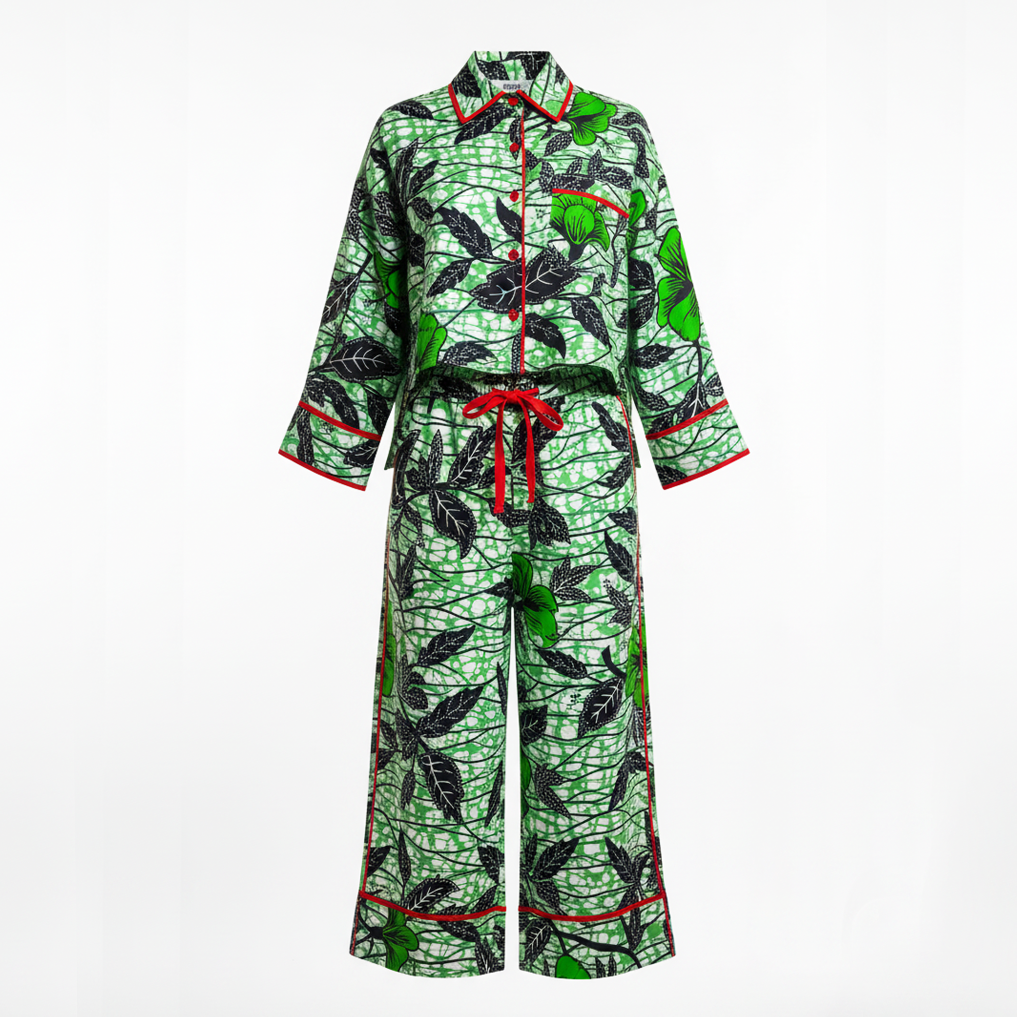 A matching two-piece pajama set featuring a green and black leaf pattern with red piping and a red waist tie, displayed on a white background.