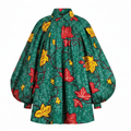 A green patterned blouse with dramatic balloon sleeves, featuring a red and yellow leaf print on a textured green background.