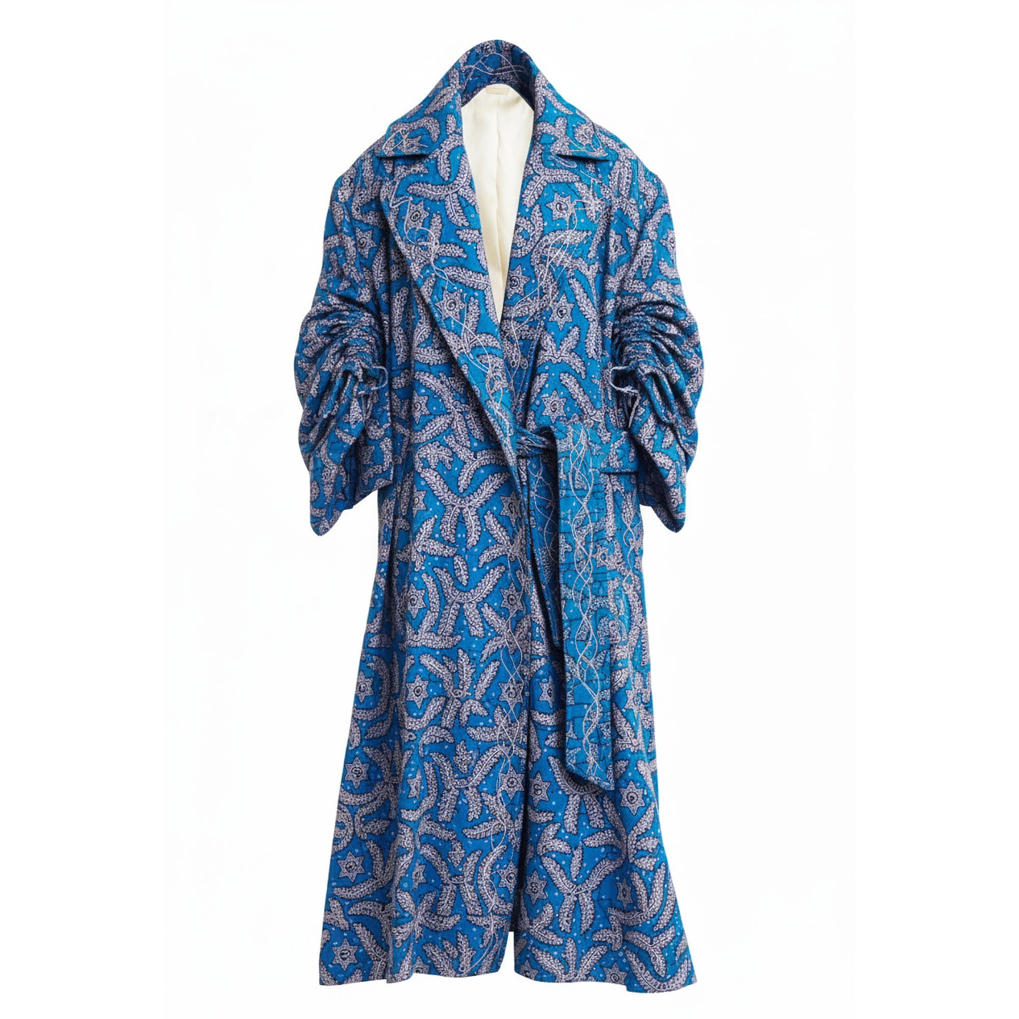 A long blue patterned coat with a white lining and matching tie belt, displayed on a mannequin against a plain white background.