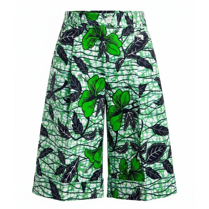 Green and black tropical print wide-leg shorts featuring hibiscus flowers and leaves over a white background with a green scribble pattern.