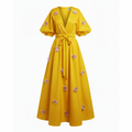 Yellow dress with floral embellishments on a white background